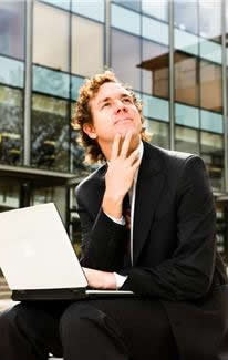 aspirations,buildings,business,businessmen,busy,contemplation,iStockphoto,laptop computers,offices,professionals,occupations,suits,thinking,working,people
